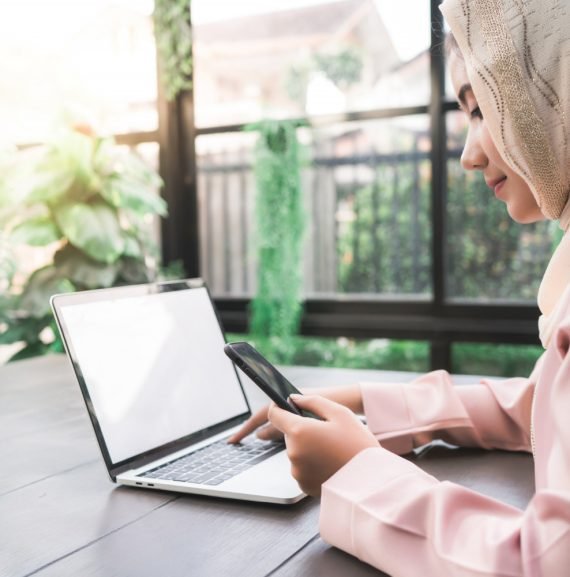 Women taking quran lesson on a laptop outdoor